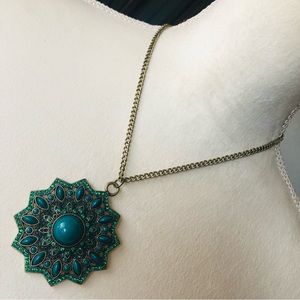 Ballet rich emerald stone covered amulet necklace